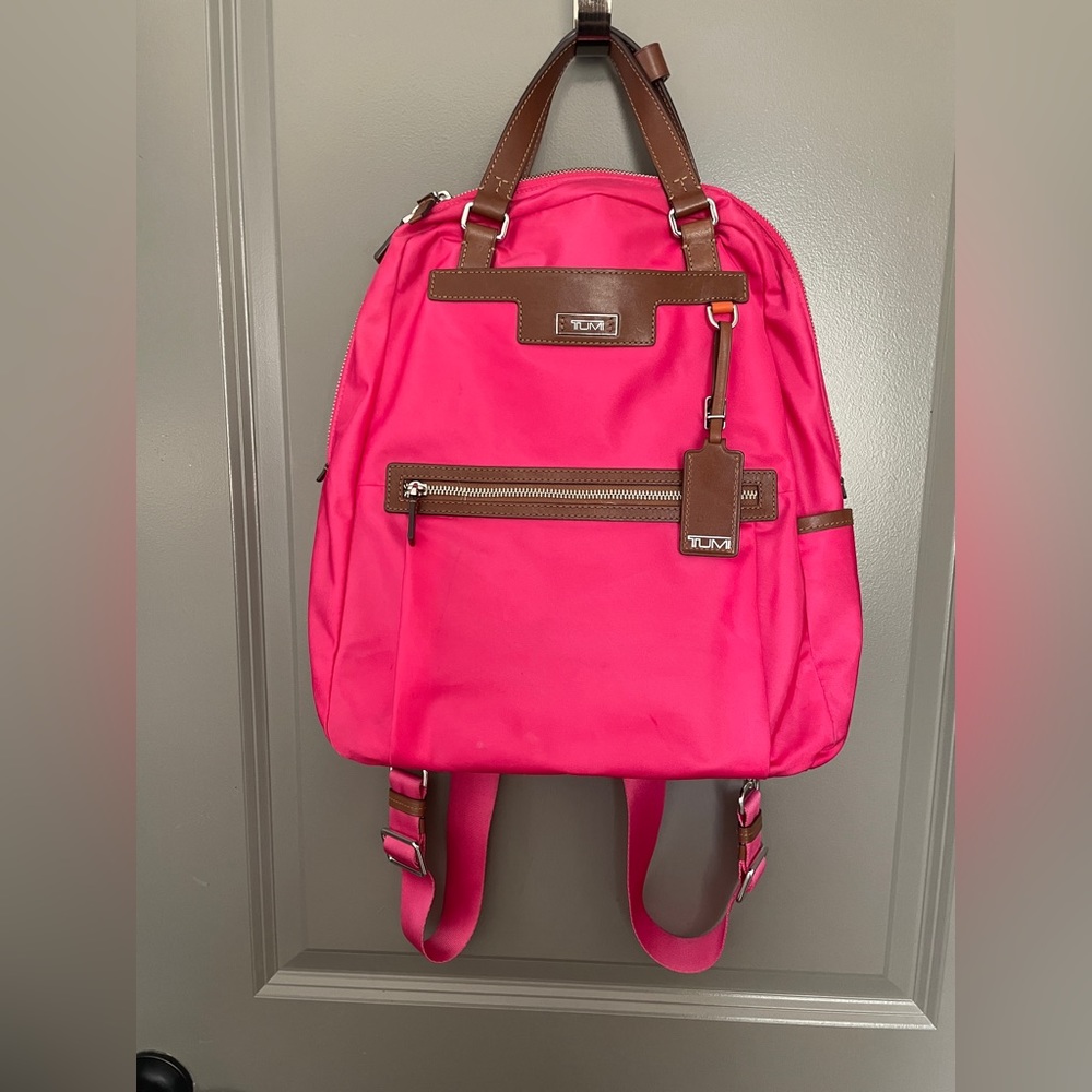 Pink Tumi nylon laptop backpack.